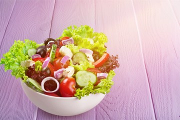 Wall Mural - Close-up photo of fresh salad with vegetables in white plate