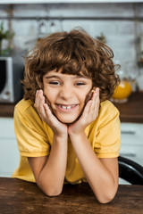 Wall Mural - cute happy boy holding pieces of delicious chocolate and smiling at camera