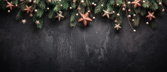 christmas decoration with fir branches and red berries on a dark background