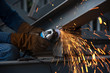 © sirisakboakaew - Worker cutting metal with grinder. Sparks while grinding iron