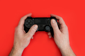 Canvas Print - Man playing video game holding gaming controller in hands