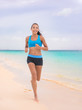 © Maridav - Active lifestyle young woman jogging on beach. Running barefoot on sand in Hawaii vacation travel Asian girl running on tropical holiday in blue activewear outfit.