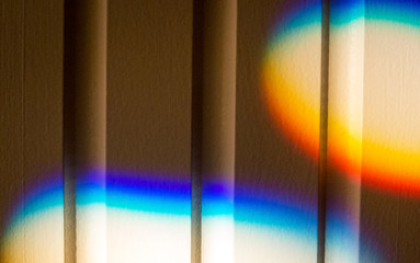 Wall Mural - Colorful refraction of the sunlight on a wall creating an abstract effect.