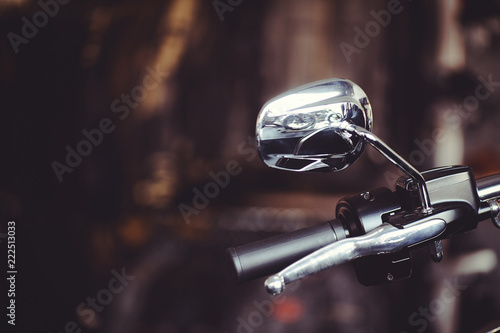 Fotografija  motorcycle rear view mirror, traffic safety on the road, on a dark background