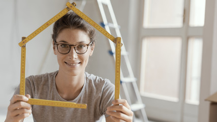 Wall Mural - Woman making a house shape with a folding ruler