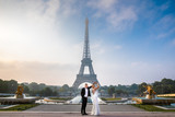 Fototapeta Paryż - bride and groom by the eiffle tower