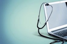 Laptop Diagnosis With  Stethoscope  On Background