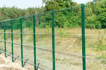 Mesh fence. Metal fence made of welded mesh.