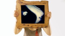 A Girl Holding A Wooden Frame With A Scene: Heavily Distorted Stylized Macro Shot Of The Eyes Of A Man Moving Fast, In Blue On Black. As Seen As I.e. A Person Under Drugs Or Having A Nightmare.

