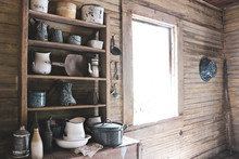 Isolated Image Of Worn Barn Wood Abandoned Slave Cabin With Various Antique Items