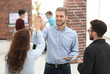 © ASDF - Photo of happy young business people holding a tablet and giving