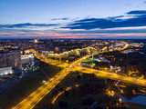 Fototapeta Miasto - Aerial top view of illuminated city road and modern apartment buildings, Minsk, Belarus
