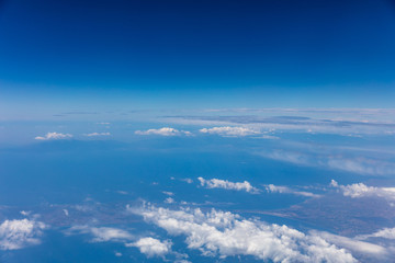Wall Mural - Cloudscape background. View out of an airplane window.