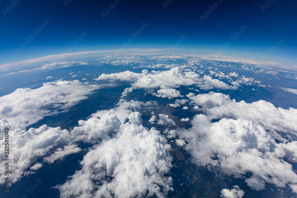 Curvature of planet earth. Aerial shot. Blue sky and clouds - obrazy, fototapety, plakaty 