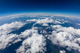 Fototapeta  - Curvature of planet earth. Aerial shot. Blue sky and clouds
