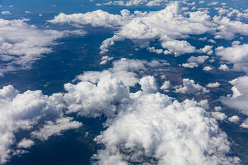 Wall Mural - Cloudscape background. View out of an airplane window.