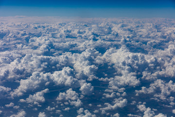 Wall Mural - Cloudscape background. View out of an airplane window.