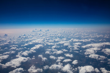 Wall Mural - Cloudscape background. View out of an airplane window.