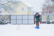 © T.Den_Team - Winter, people and problem concept - closeup of man digging snow with shovel near car and yard. Man standing with blue shovel and he snow cleaning. Winter routine concept.