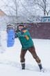 © T.Den_Team - Winter, people and problem concept - closeup of man digging snow with shovel near car and yard. Man standing with blue shovel and he snow cleaning. Winter routine concept.