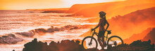 Sport Biking Cyclist Looking At Ocean Beach Coastline During Cycling Trail Race Trip. Silhouette Of Woman Athlete Training Mountain Bike Outdoors At Sunset, Banner Panorama.