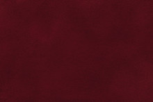 Background Of Dark Red Suede Fabric Closeup. Velvet Matt Texture Of Wine Nubuck Textile