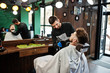 © AS Photo Family - Handsome bearded man at the barbershop, barber at work.