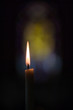Single candle with yellow and blue background