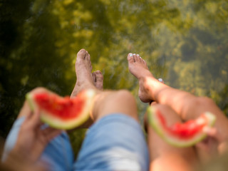 Couple eating watermelon enjoying picnic time