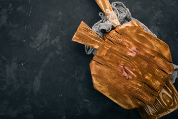 Wall Mural - Kitchen old wooden board. On a black background. Free space for text. Top view.