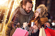 © Kalim - Adult couple shopping in the city during Christmas time