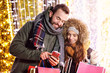 © Kalim - Adult couple shopping in the city during Christmas time
