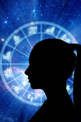 woman silhouette over astrology background with zodiac signs and horoscope