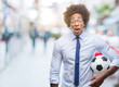 Afro american manager man holding soccer ball over isolated background scared in shock with a surprise face, afraid and excited with fear expression