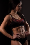 Caucasian fitness instructor female in active wear, demonstrates her  perfect body shape. Cropped studio shot of a stunning hot sporty body of a  fitness woman Stock Photo