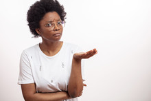 Uncertain African Woman With Open Palm Asking Something. Unhappy Balck Female With Puzzled Expression. Copy Space. Isolated White Background.