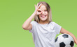 © Krakenimages.com - Young beautiful girl holding soccer football ball over isolated background with happy face smiling doing ok sign with hand on eye looking through fingers