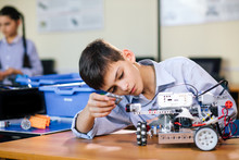 Little Boy In Robotics School Makes Robot Managed From The Constructor, Child Learns Robot Constructing.