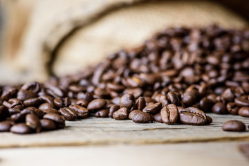 Fresh roasted coffee beans on rustic wood background