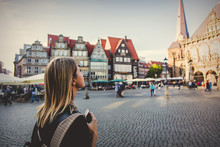 Young Lady In Dress On Medieval Street Of Bremen, Germany. Trevel Destination Concept