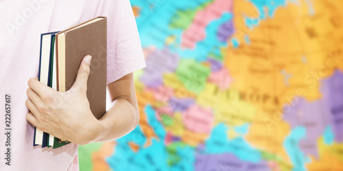 student hand with books and map, learn languages Canvas Print