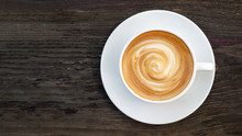 Hot Coffee Cappuccino Latte Spiral Foam Top View On Dark Wooden Background