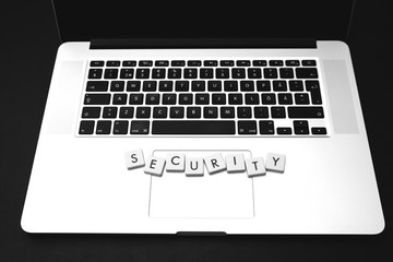 Wall Mural - security text on top of a modern laptop. image in black and white.
