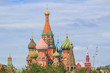St. Basil's Cathedral on Red square in Moscow against green trees and sky with clouds on a summer day
