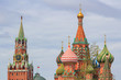 Domes of St. Basil's Cathedral with Spasskaya tower in Moscow against dramatic cloudy sky at summer day