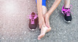 © miccolino - Running injury leg accident- sport woman runner hurting holding painful sprained ankle in pain.Athlete woman has ankle injury, sprained ankle during running training.Space for text