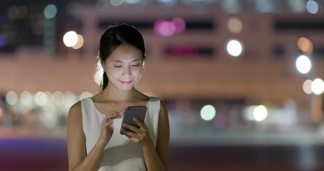 Wall Mural - Woman look at mobile phone in the evening