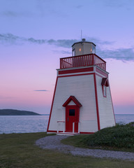 Fototapete - Fox Point Lighthouse at sunset in St. Anthony, Newfoundland