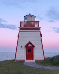 Fototapete - Fox Point Lighthouse at sunset in St. Anthony, Newfoundland