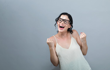 Wall Mural - Successful young woman on a solid background